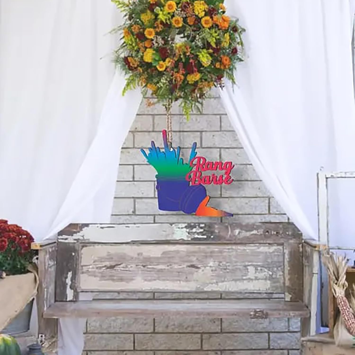 Decorative sign with colorful hand design and 'Ring Bearer' text on a wooden chest against a stone wall.
