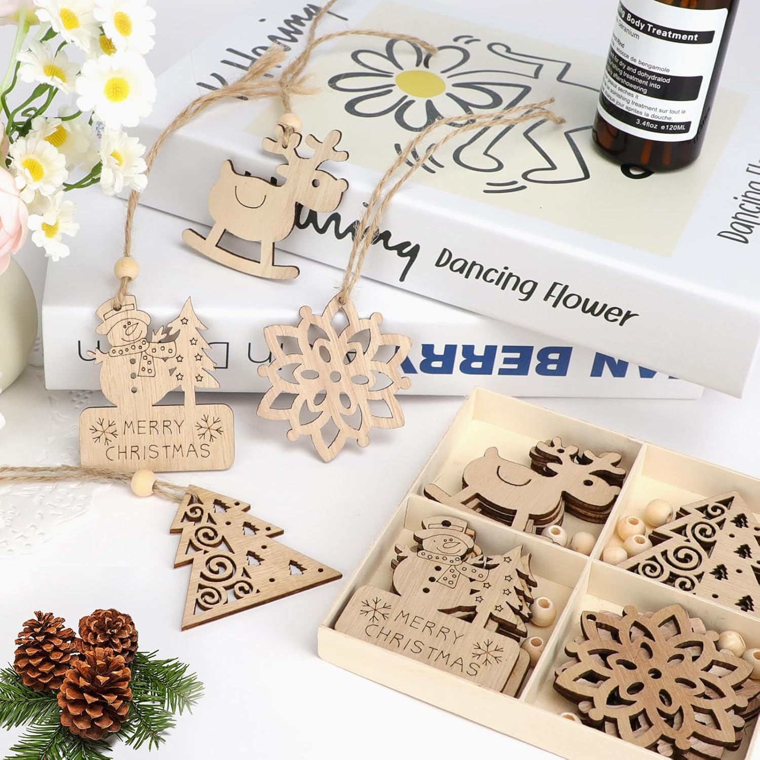 Wooden Christmas ornaments in a box with decorative items on a table.