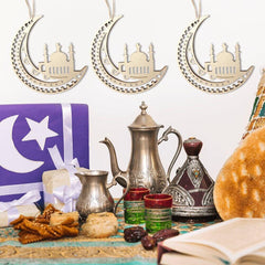 Decorative items including teapots, cookies, and a book on a table with a star and crescent moon design in the background.