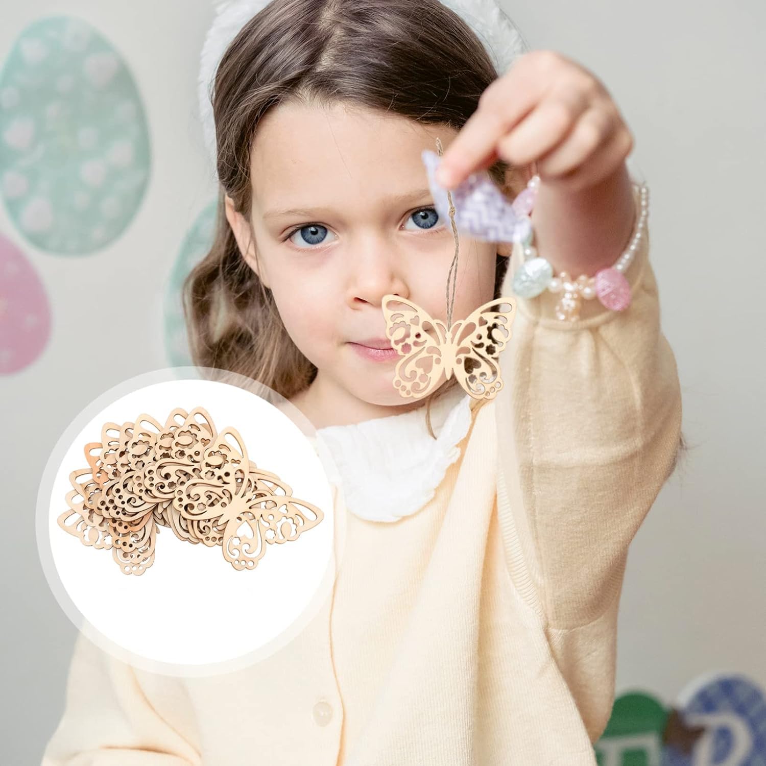 Young girl holding a decorative butterfly charm with a close-up inset of the same item.