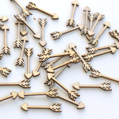 Wooden arrow-shaped objects scattered on a white background