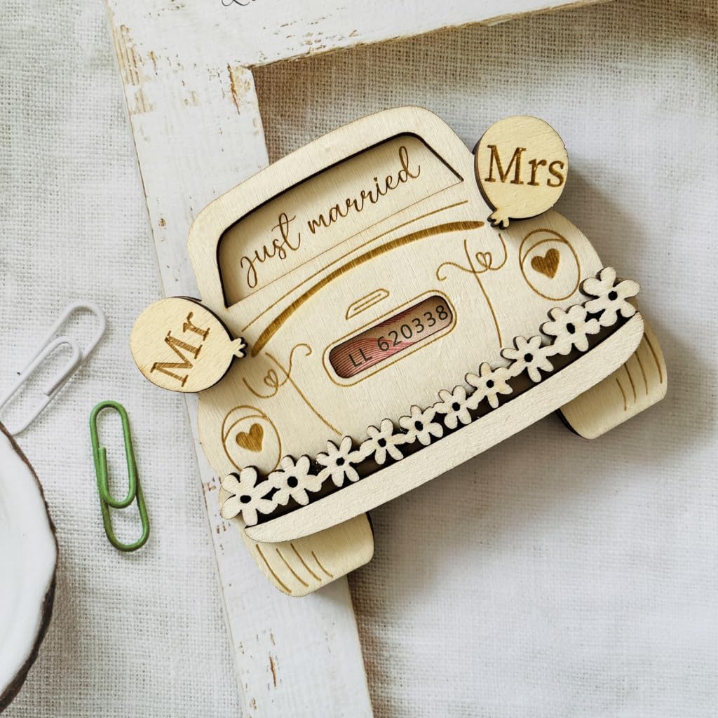 Wooden decorative item shaped like a car with 'just married' and 'Mr & Mrs' text on a textured surface.