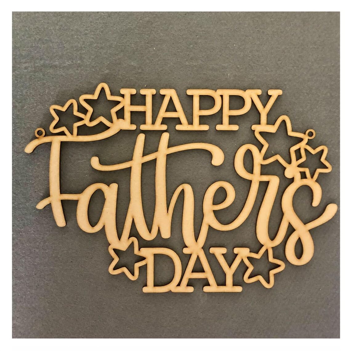 Wooden decorative sign with 'Happy Father's Day' text on a gray background