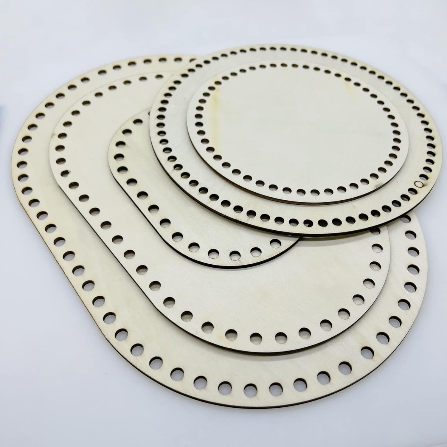 Set of metallic circular components with holes on a white background