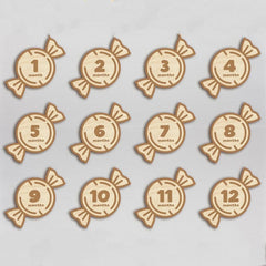 Wooden baby milestone markers with numbers 1 to 12 months on a light gray background