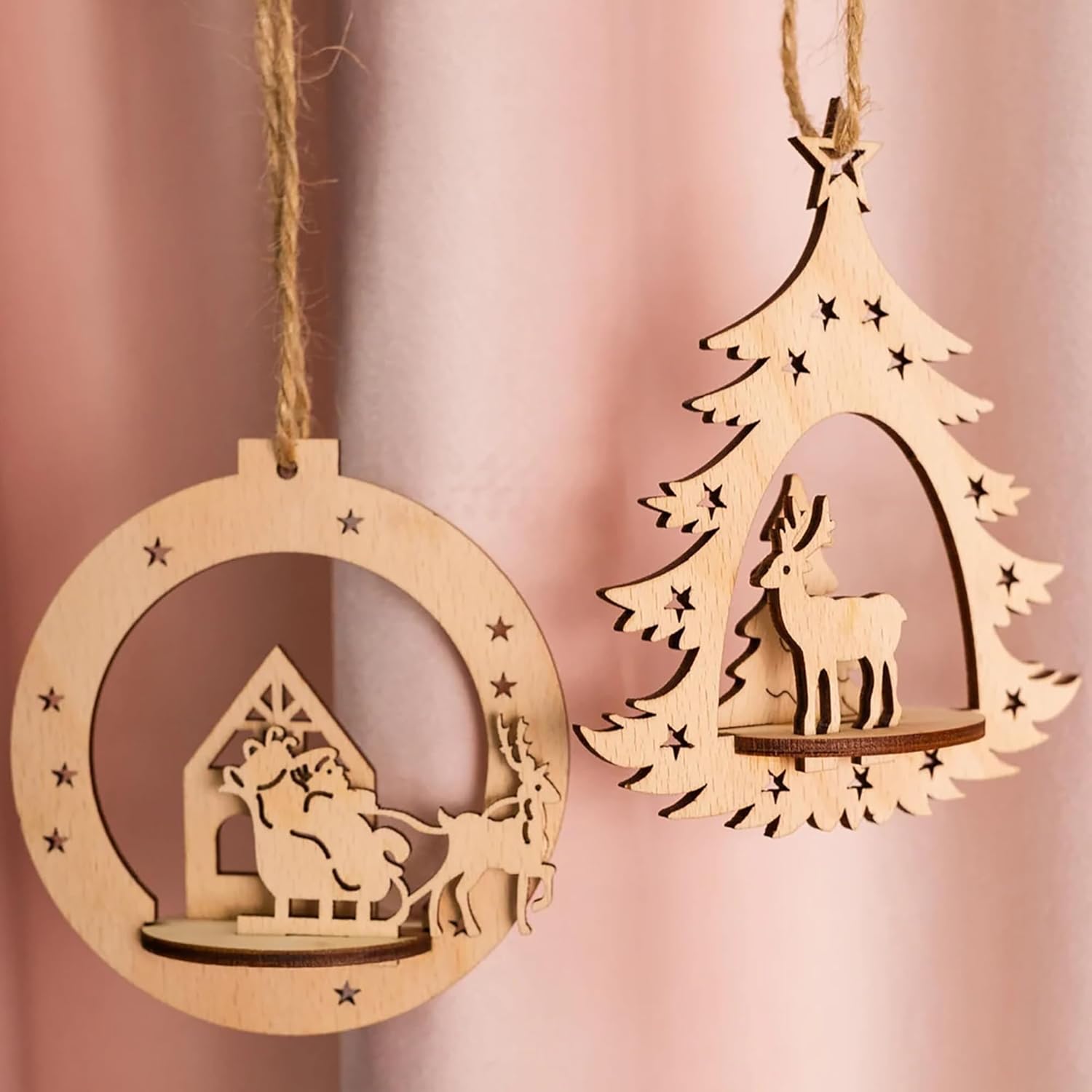 Two wooden Christmas ornaments on a pink background