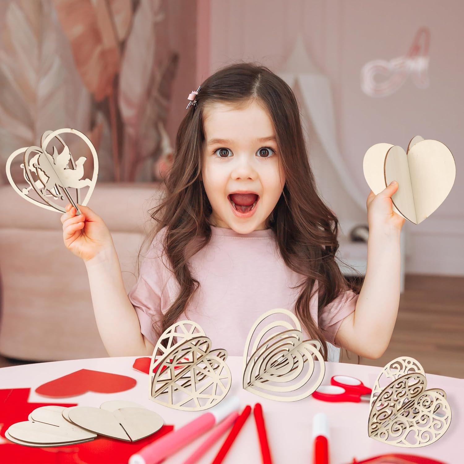 Child holding heart-shaped crafts with a blurred indoor background
