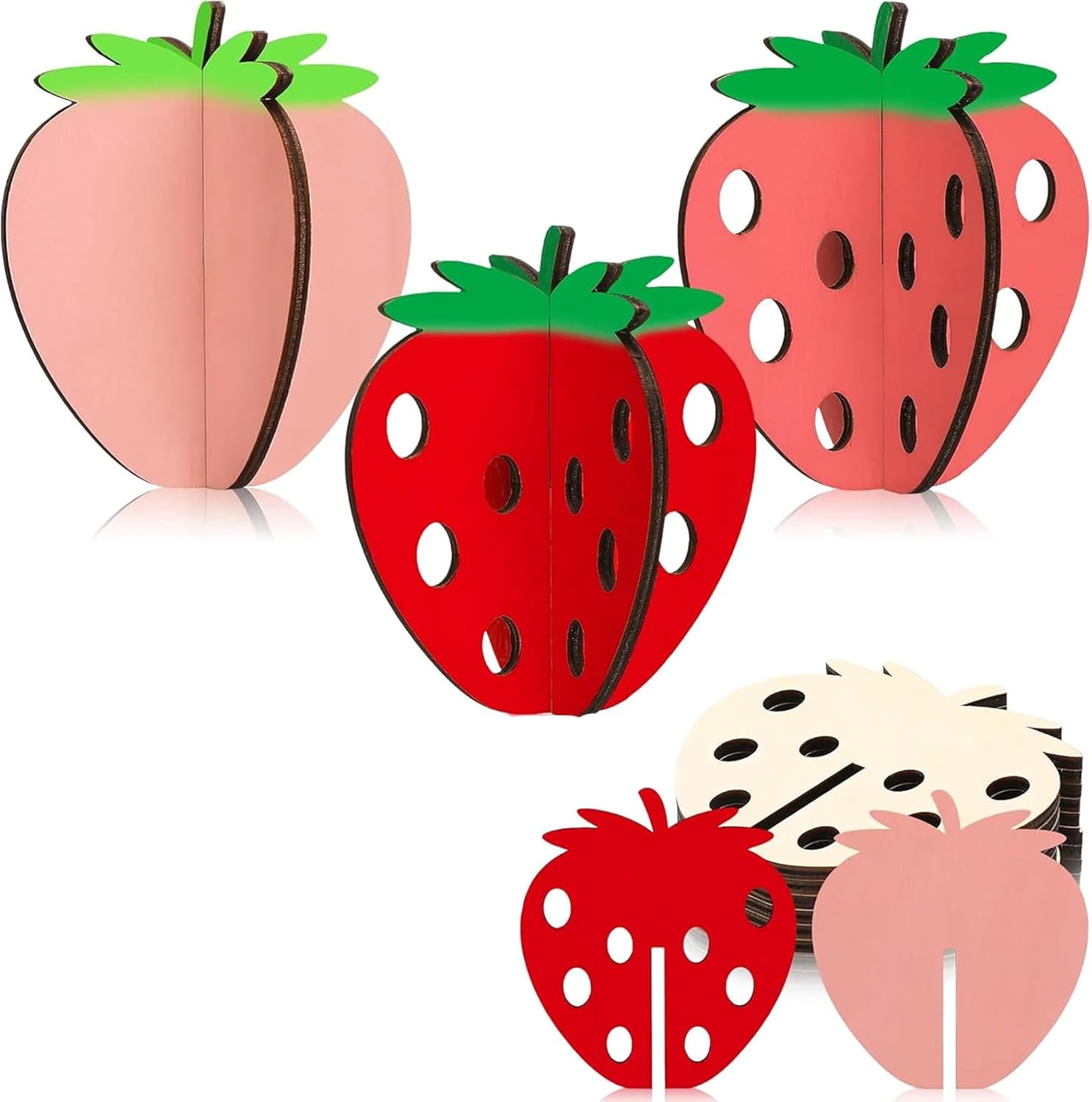 Set of strawberry and peach-shaped paper decorations on a white background