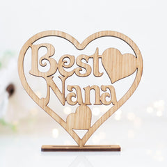 Wooden heart-shaped sign with 'Best Nana' text on a white background