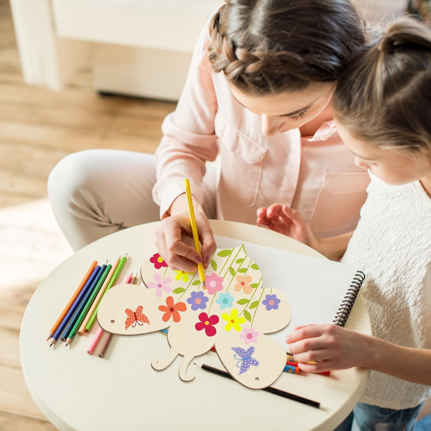 Two children drawing on wooden boards with colorful markers and pencils.