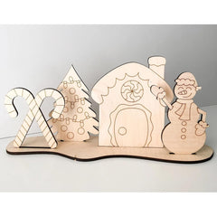 Wooden Christmas-themed set with house, tree, candy cane, and snowman on a white background