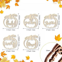 Set of wooden pumpkin-shaped decorations with engraved words and measurements, surrounded by autumn leaves.