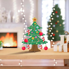 Decorative Christmas tree on a stand with ornaments in a festive setting.