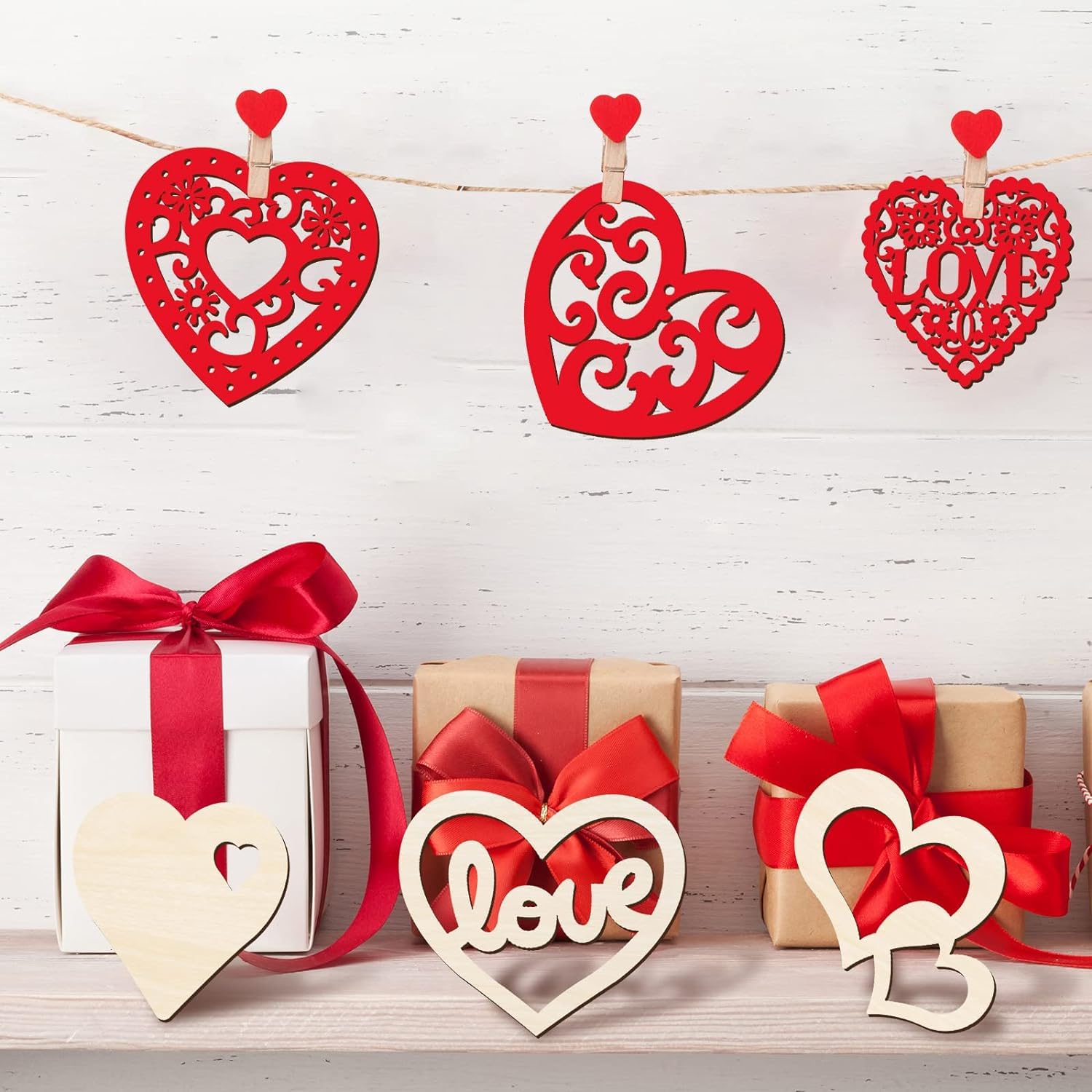Decorative red hearts with 'love' on a white wooden background