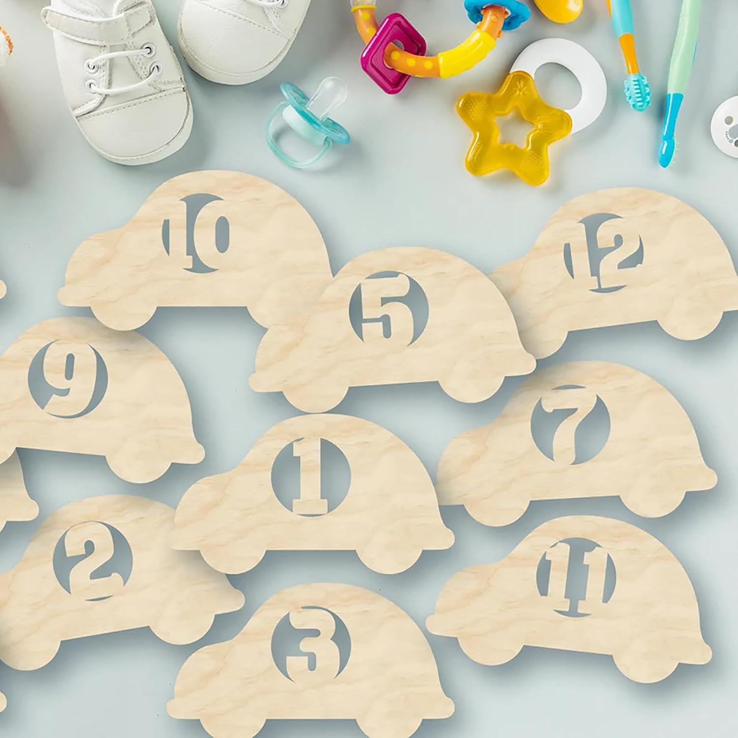 Wooden turtle-shaped numbers on a light blue background with baby items around