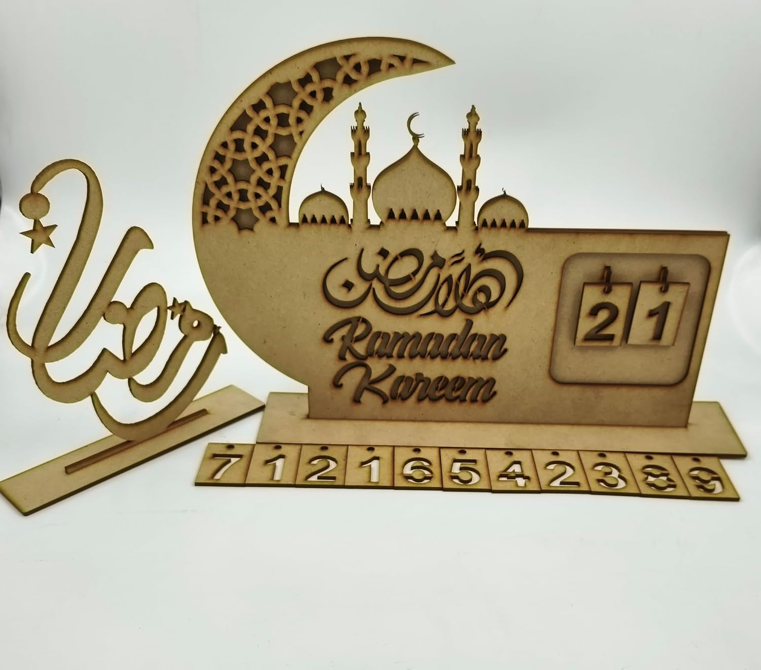 Wooden Ramadan decorative item with crescent moon, mosque silhouette, and 'Ramadan Kareem' text on a white background.