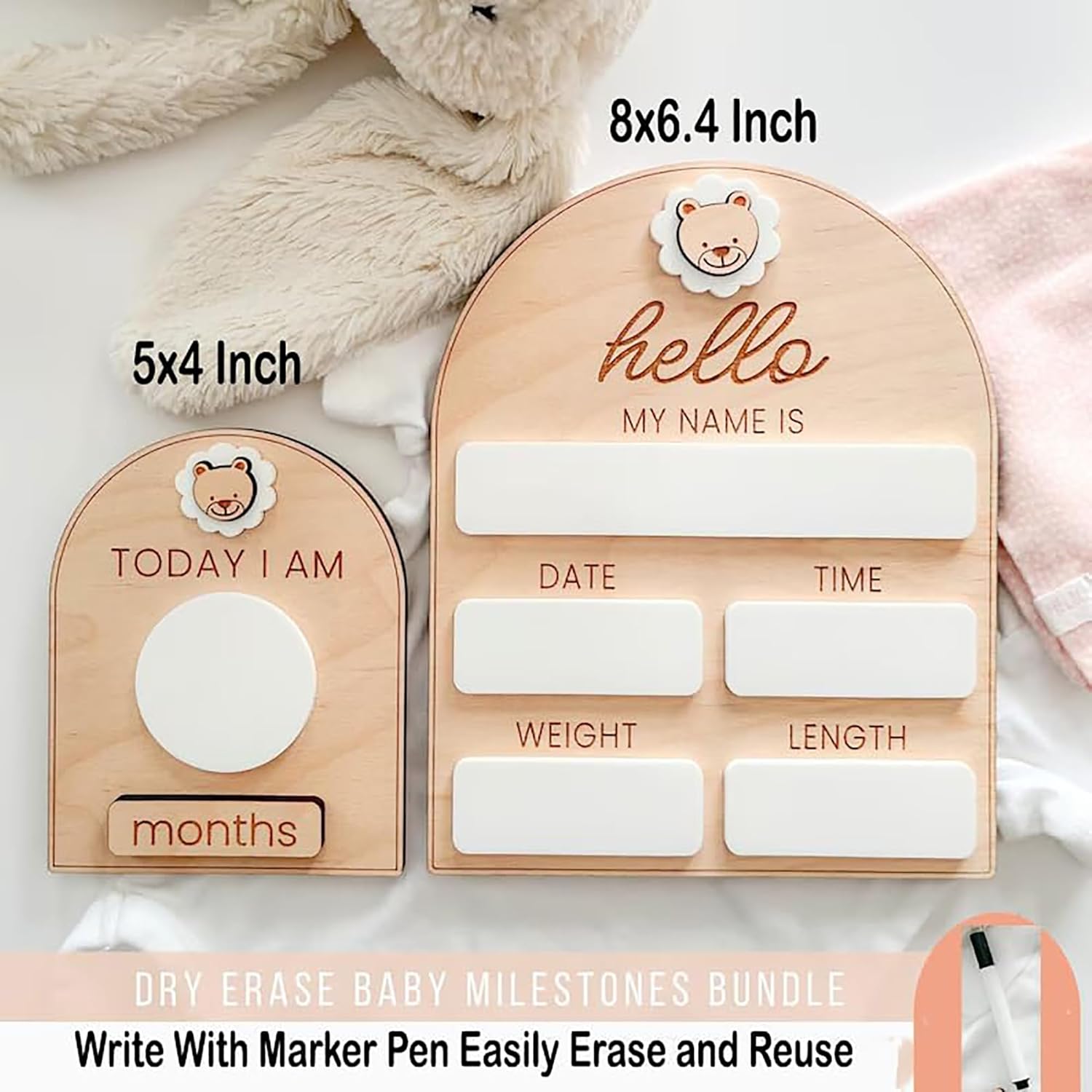 Wooden baby milestone boards with dry erase markers on a soft background