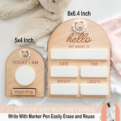 Wooden baby milestone boards with dry erase markers on a soft background