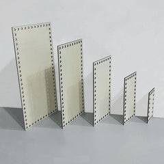 Set of metal display stands with perforated design on a gray surface and light gray background