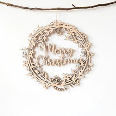 Wooden wreath ornament with 'Merry Christmas' text on a white background