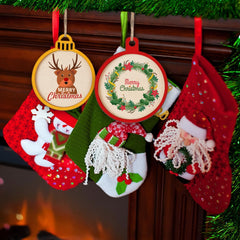 Christmas-themed decorations including stockings and ornaments hanging on a tree.