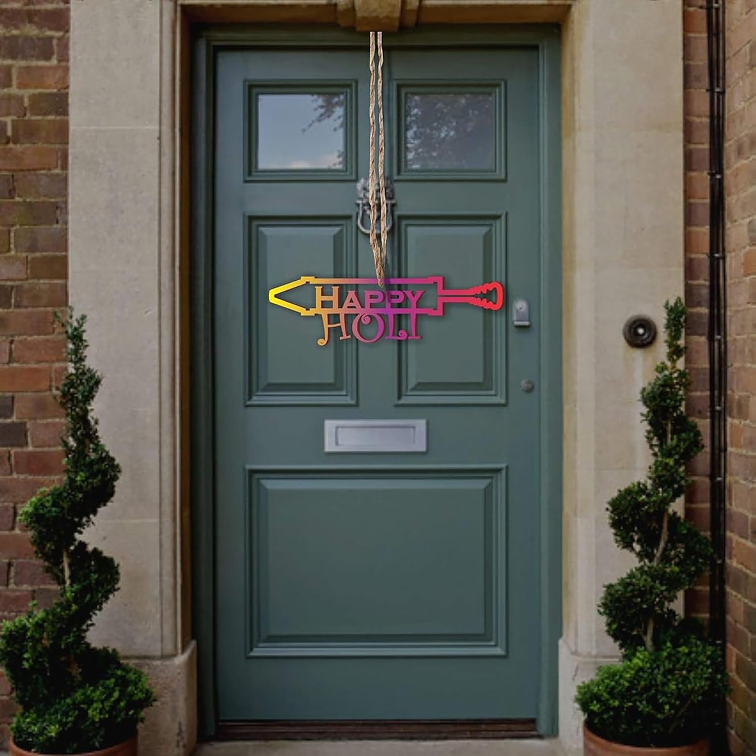 Green door with a decorative sign reading 'Happy Holly' on a brick building.