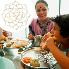 Woman and child eating at a table with food and a decorative 'Om' symbol.