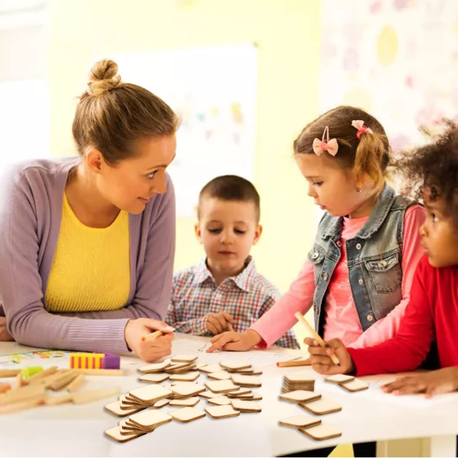Woman and two children sitting at a table with wooden utensils
