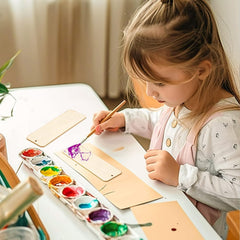 Child painting with watercolors at a table