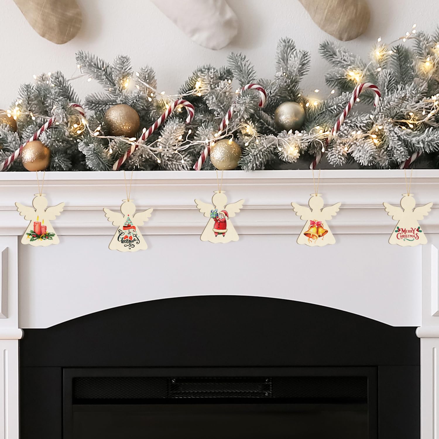 Decorative Christmas mantel with garland, ornaments, and angel banners above a fireplace.