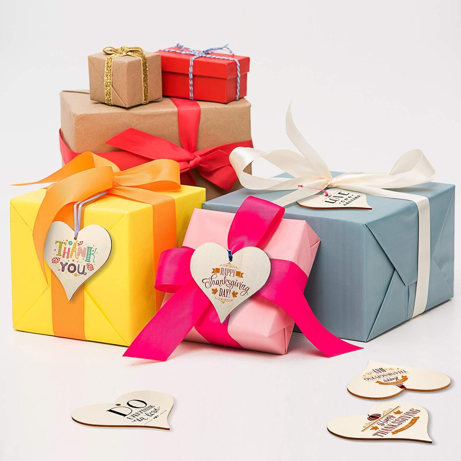Colorful gift boxes with ribbons and heart-shaped tags on a white background