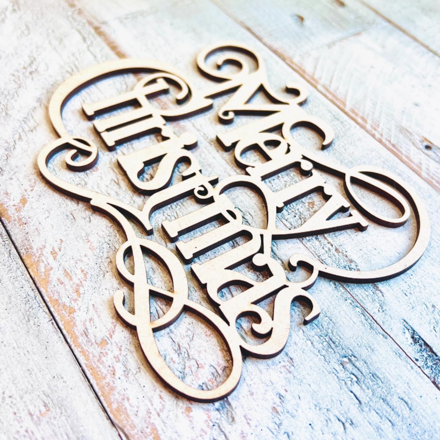 Decorative wooden cutout with 'Happy New Year' text on a rustic wooden surface