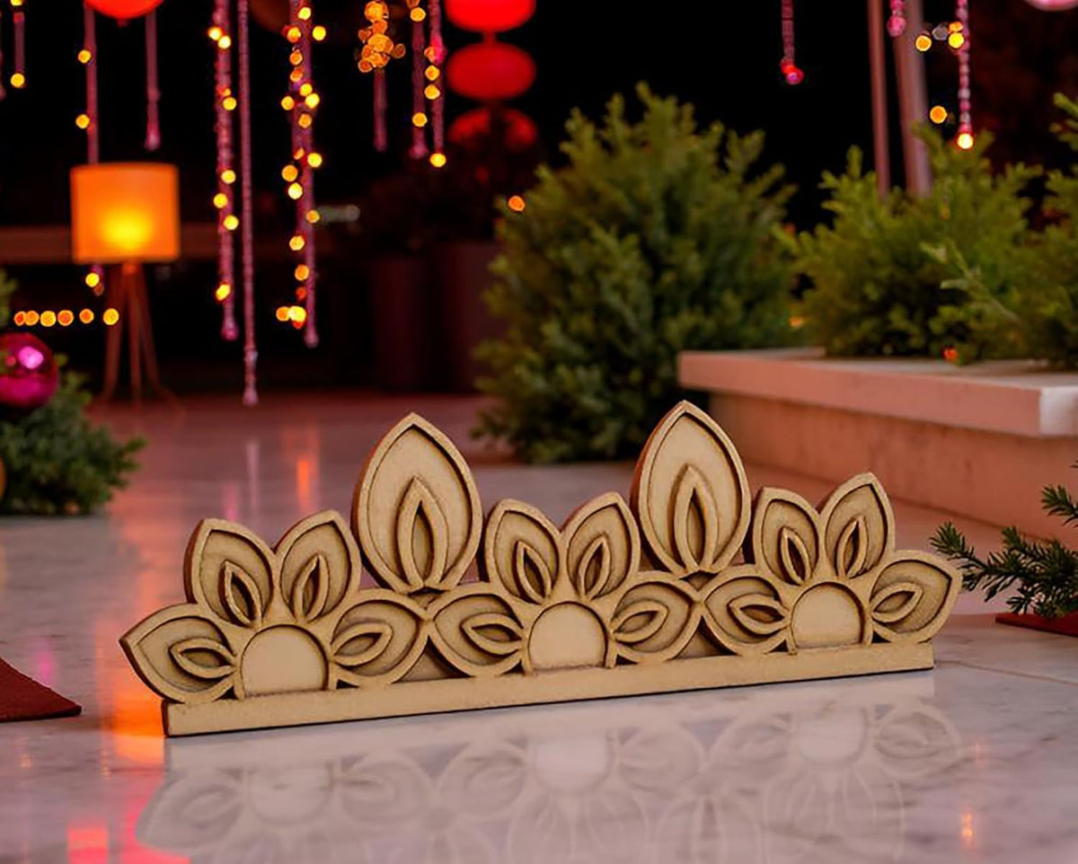 Decorative wooden piece with leaf design on a reflective surface, blurred festive background
