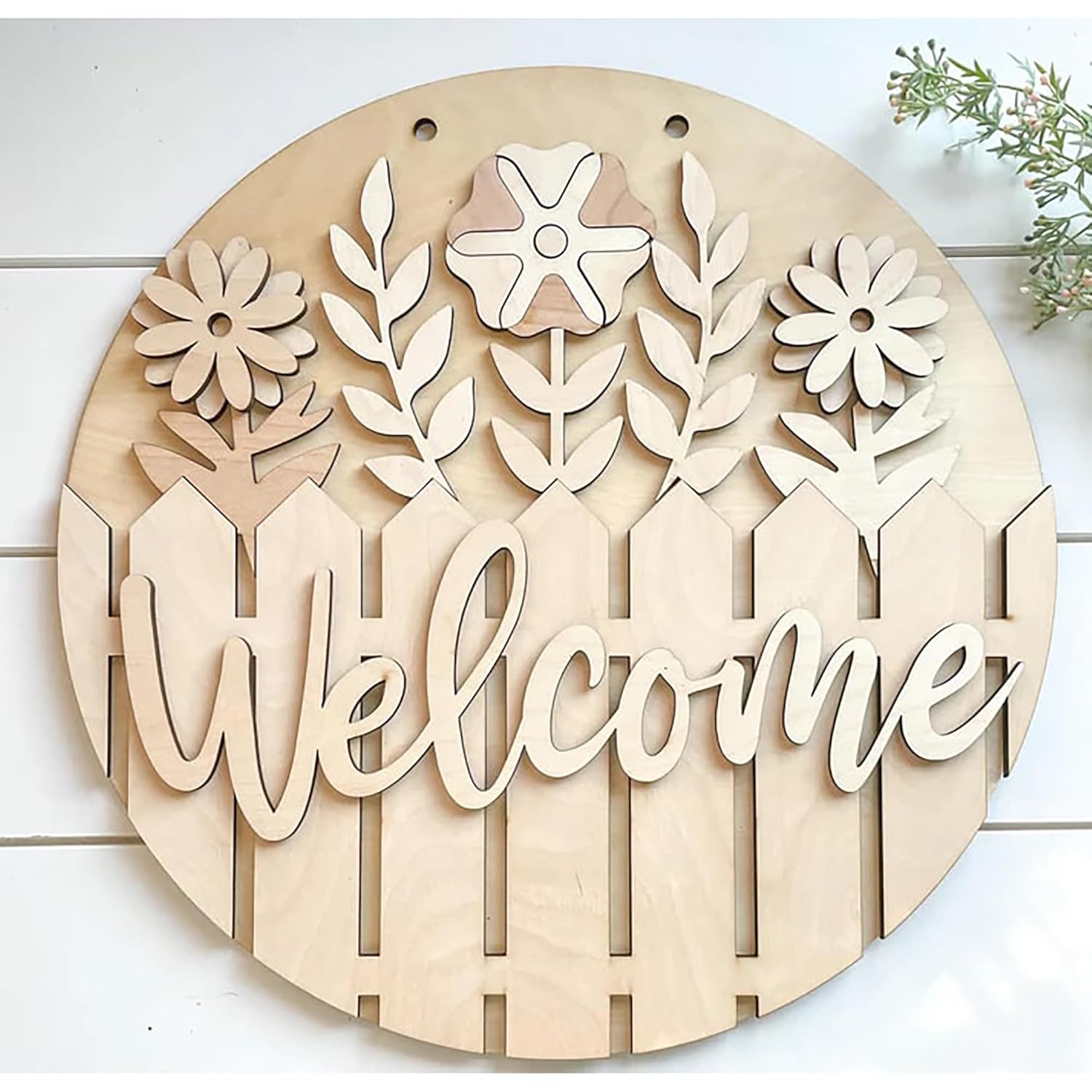 Wooden decorative sign with floral designs and the word 'Welcome' on a white background