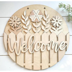 Wooden decorative sign with floral designs and the word 'Welcome' on a white background