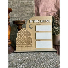 Wooden Iftar menu board with Ramadan Mubarak design on a textured surface.
