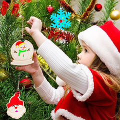 Child in a Santa hat holding a Christmas ornament with a decorated tree in the background