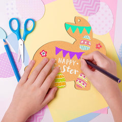 Child's hands coloring a paper Easter bunny with markers on a colorful background.