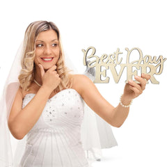 Bride holding a 'Best Day Ever' sign against a white background