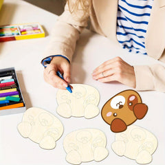 Person coloring a cartoon dog design on paper with crayons.