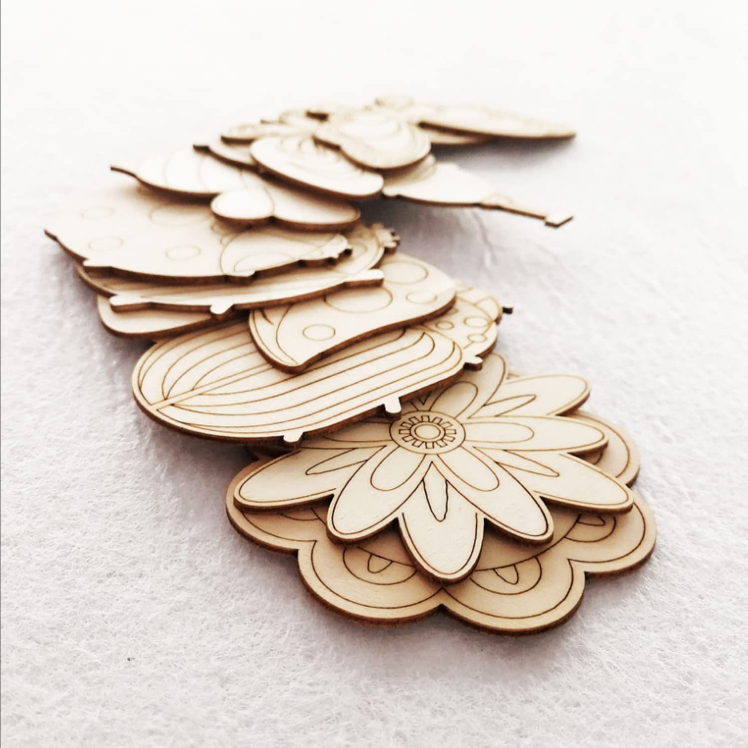 Wooden cutout shapes of flowers on a white background