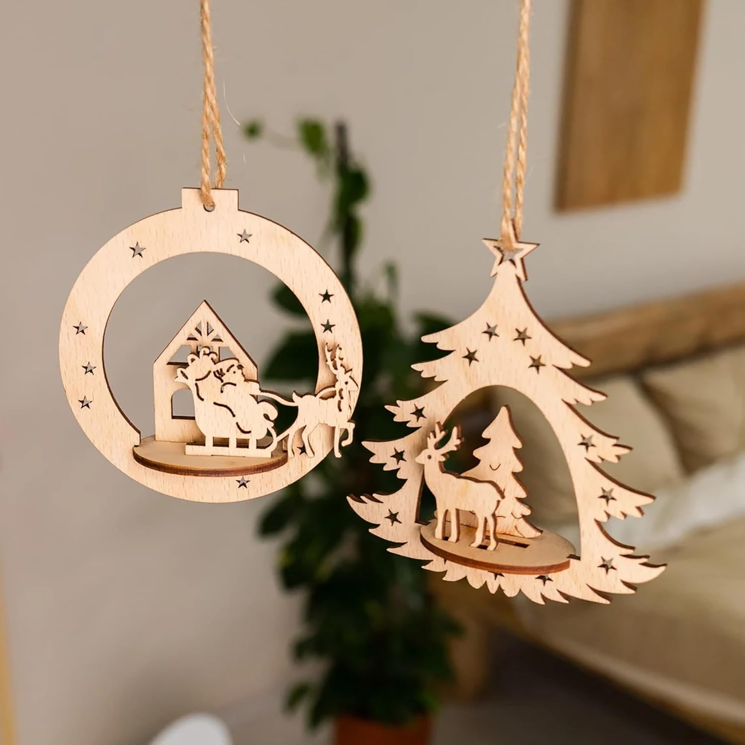 Two wooden Christmas ornaments hanging against a neutral background