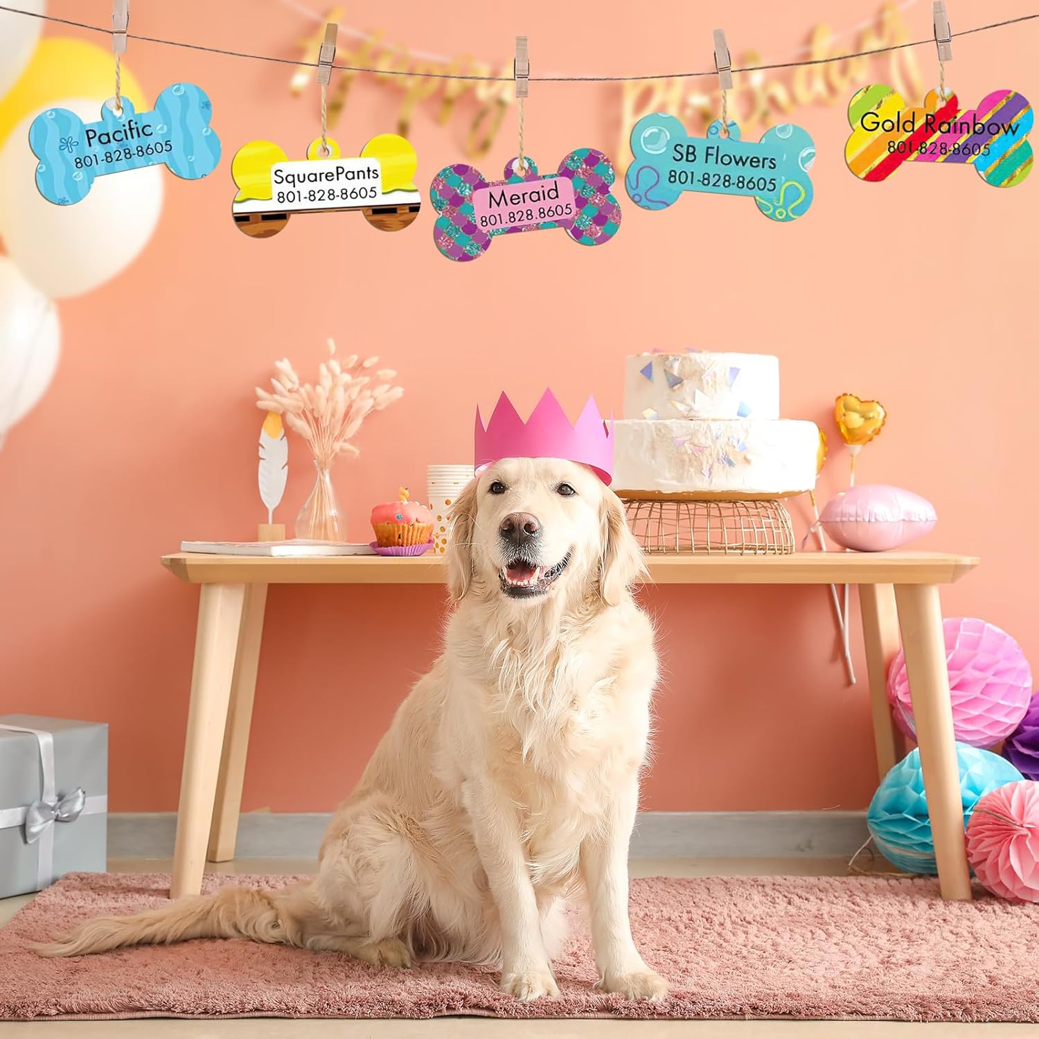 Dog wearing a pink crown in a decorated room with balloons and a cake.