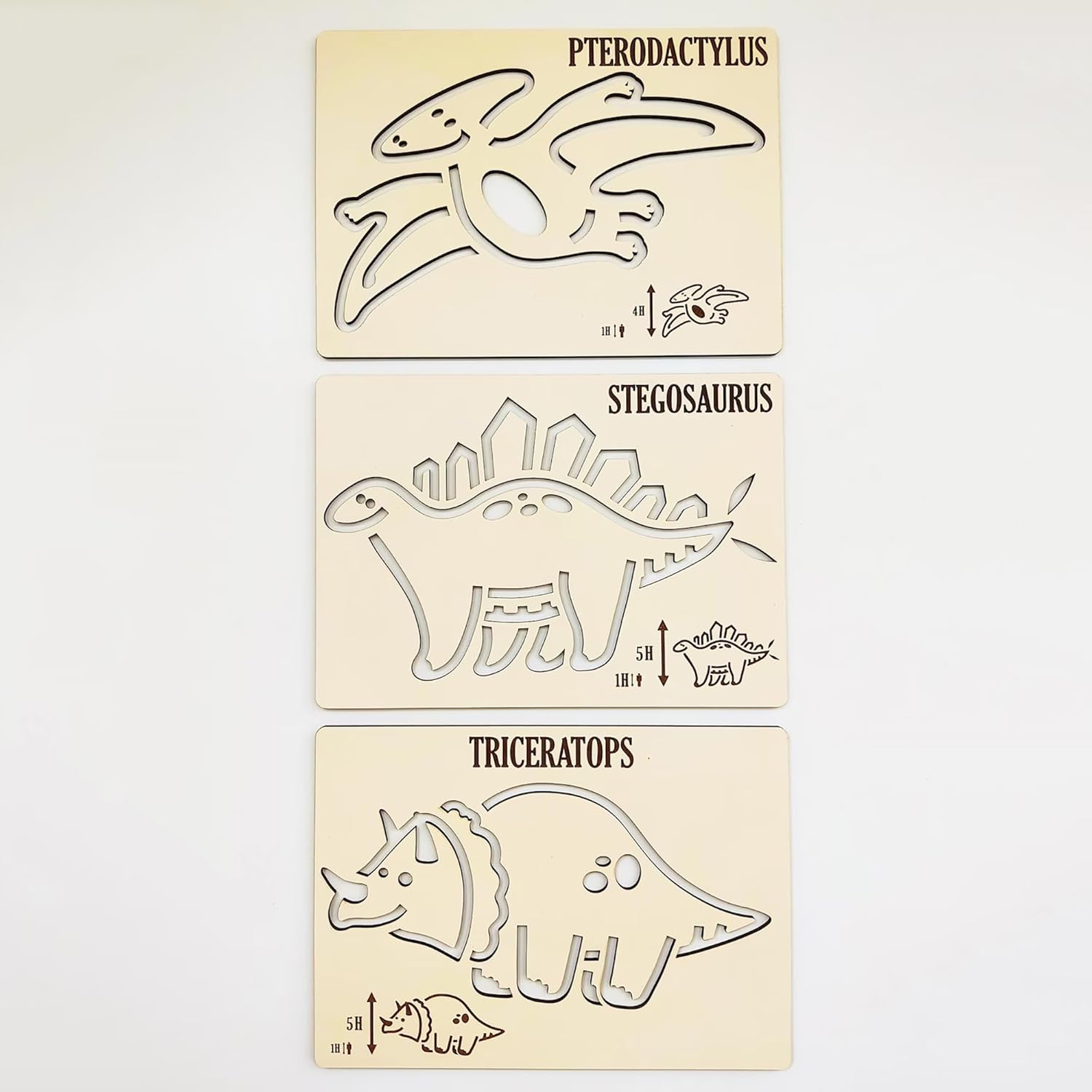 Three dinosaur stencils for drawing on paper, labeled Pterodactylus, Stegosaurus, and Triceratops.