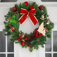 Decorative Christmas wreath with red bow, berries, and small gifts on a white door.
