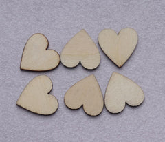 Six wooden heart shapes on a gray background