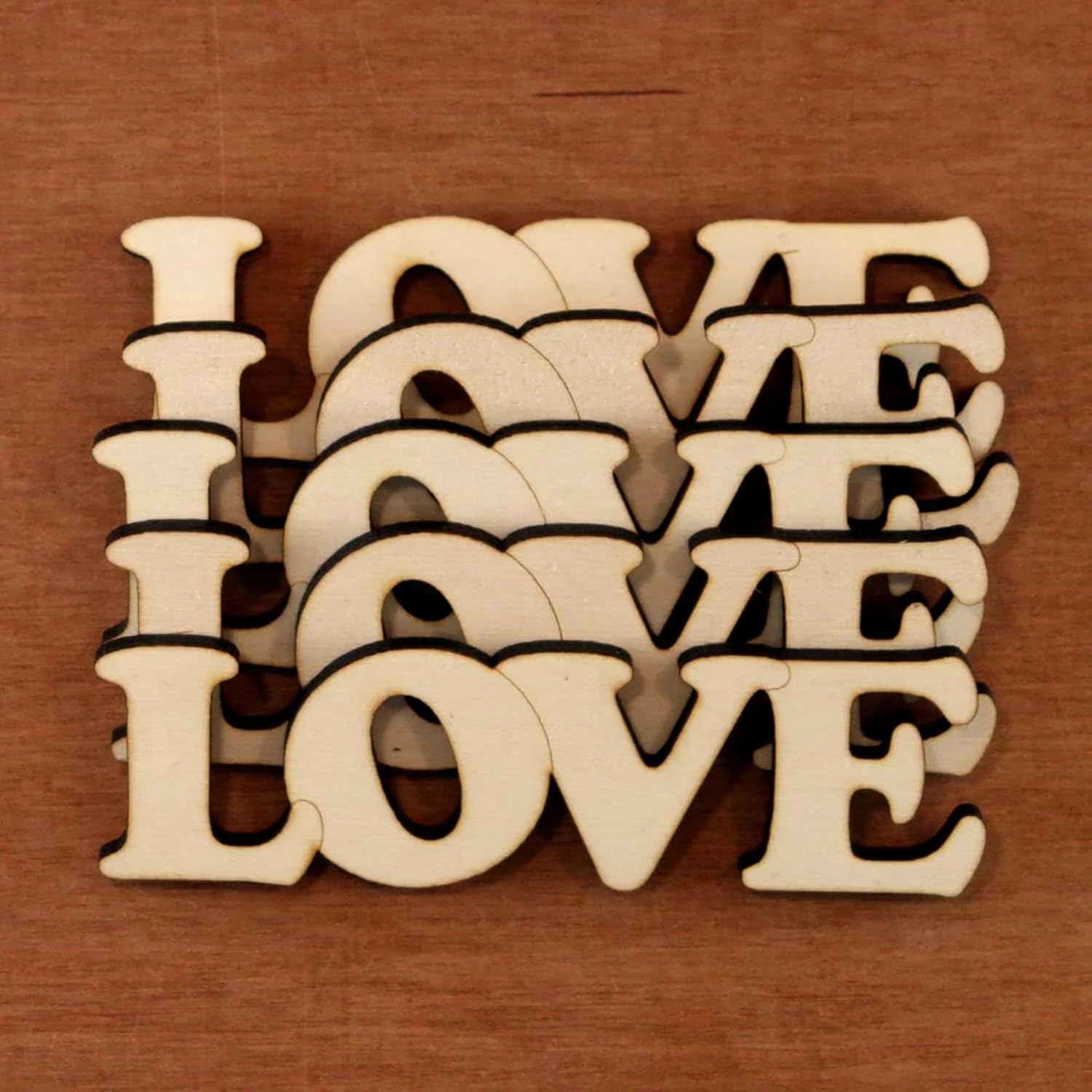 Wooden letters spelling 'LOVE' on a wooden background