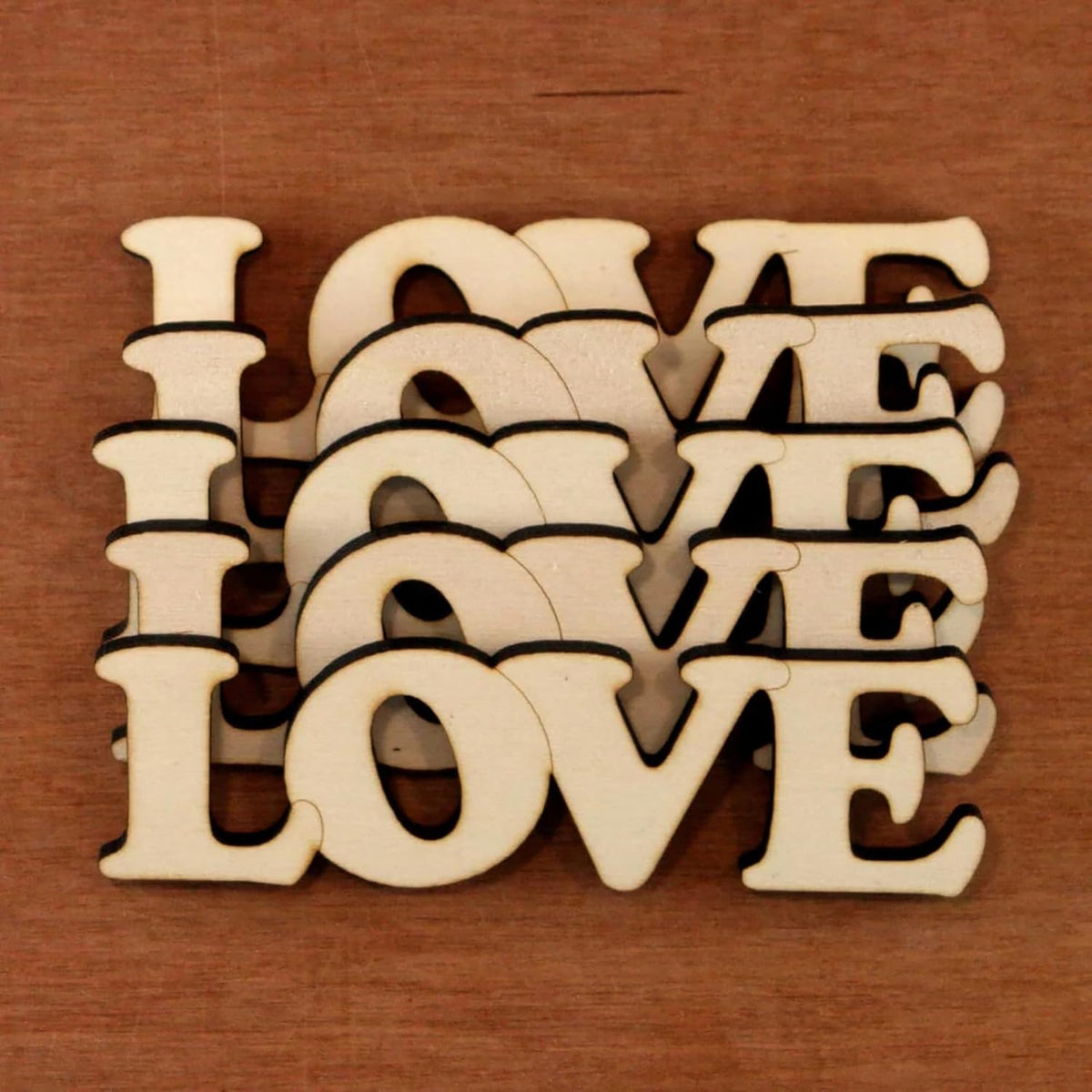 Wooden letters spelling 'LOVE' on a wooden background