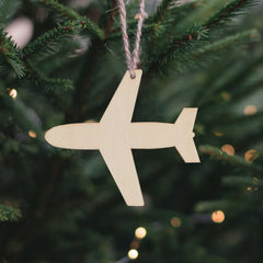Wooden airplane ornament hanging on a Christmas tree