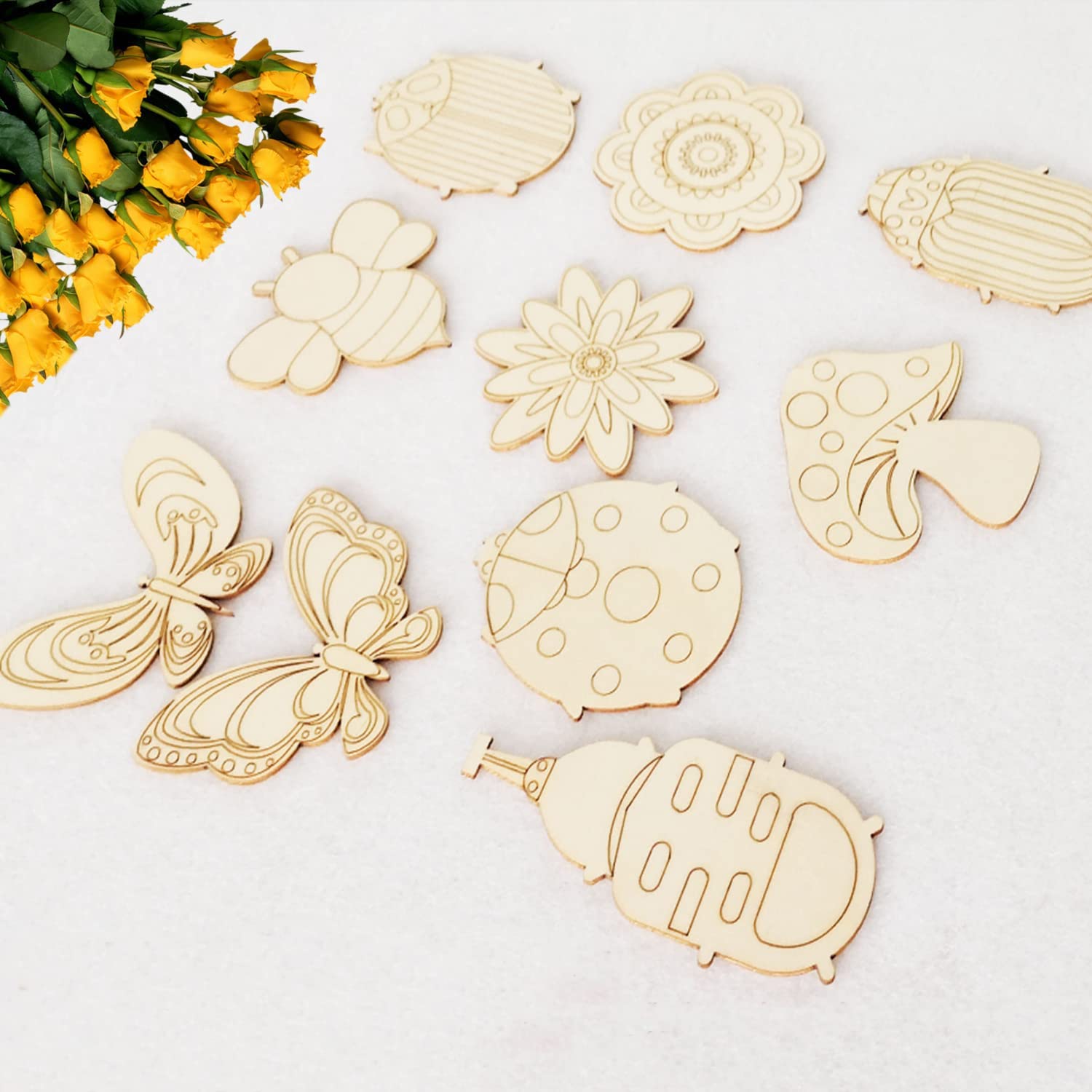 Wooden cutouts of various shapes on a white background with yellow flowers.